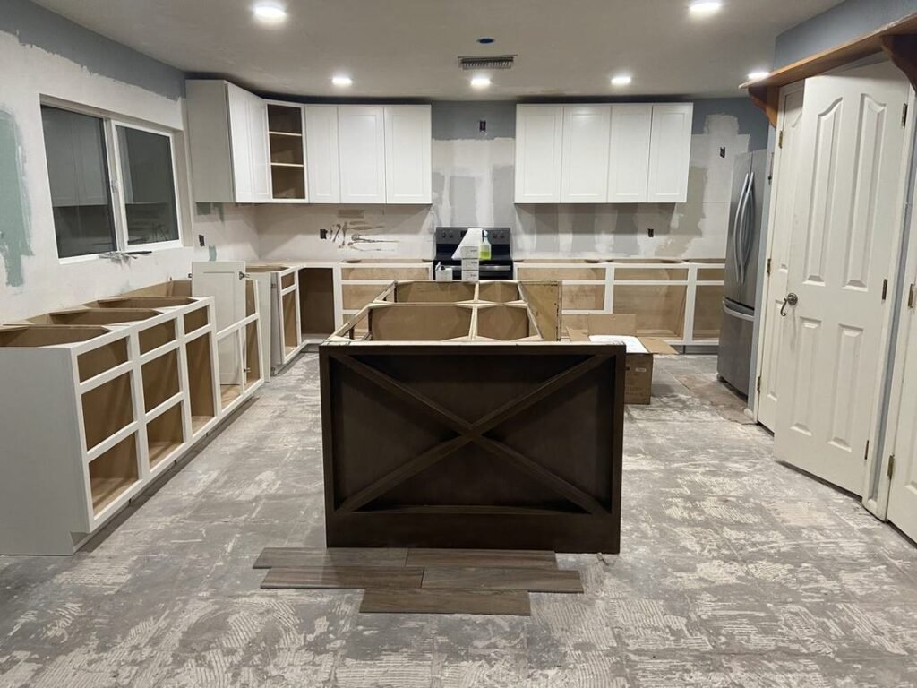 Base cabinets and island frame being installed mid-remodel